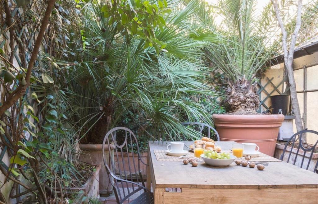a wooden table with a bowl of fruit on it at Palm Fronds in Milan