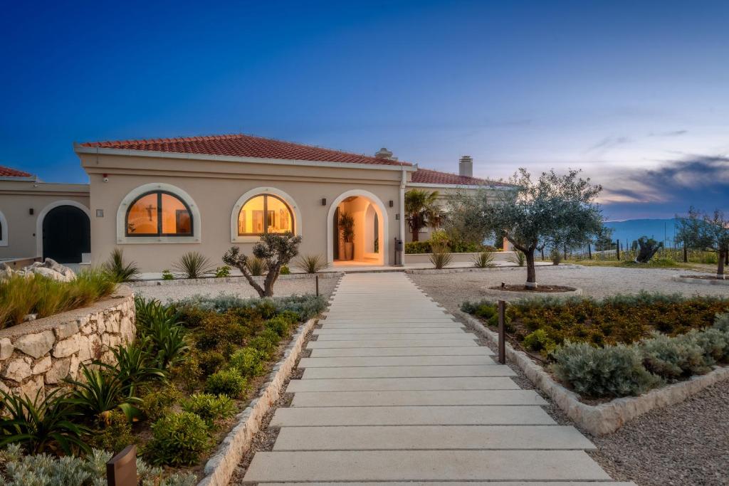 a home in the desert with a pathway at Winery Rizman B&B in Slivno Ravno