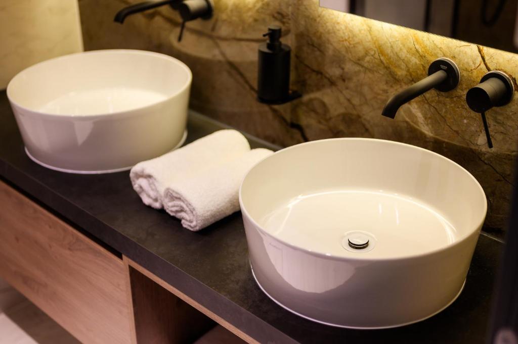 a bathroom with two sinks on a counter at Winery Rizman B&B in Slivno Ravno