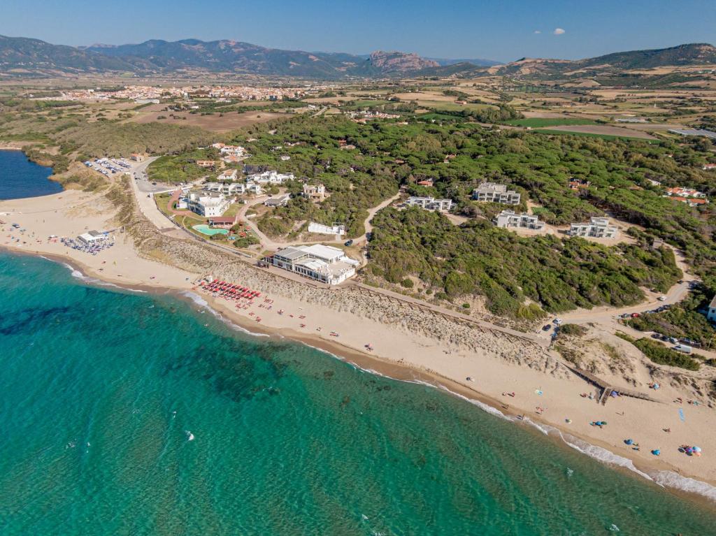 an aerial view of a beach with a group of people at Bellevue Sardinia Resort, Affiliated by Meliá in Valledoria
