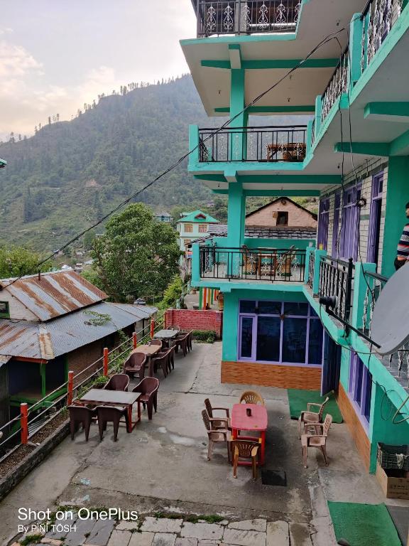 a balcony of a building with tables and chairs at Sunset Inn tosh in Tosh
