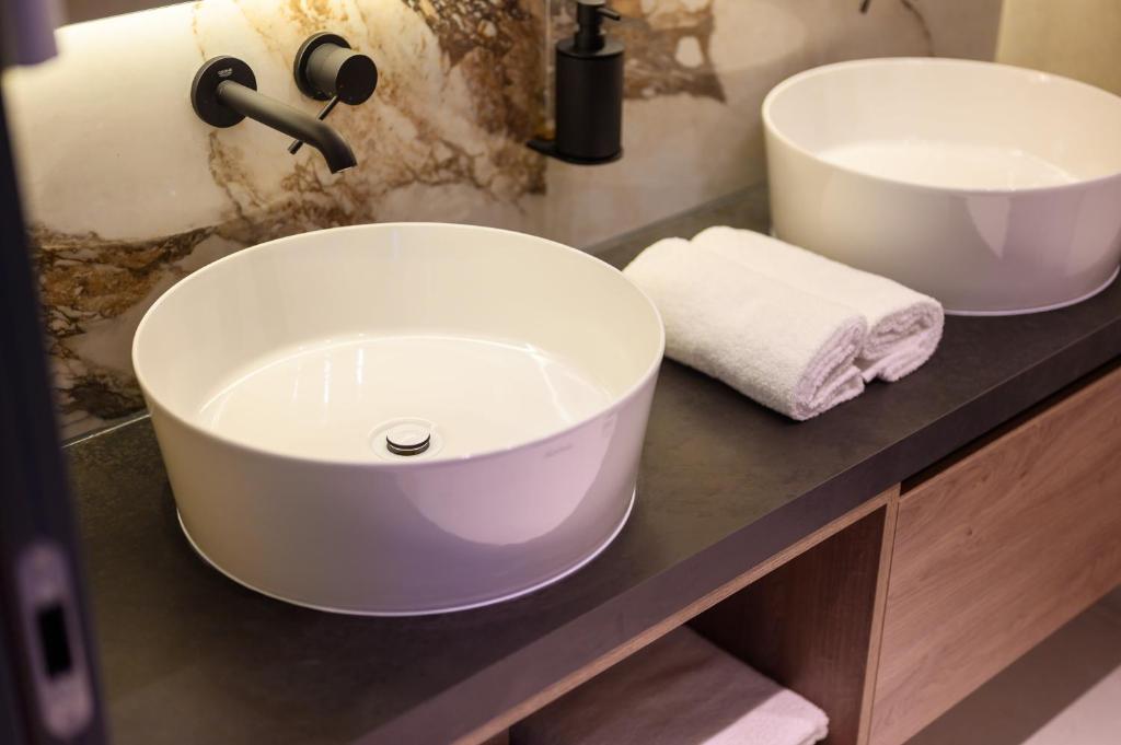 a bathroom with two sinks on a counter at Winery Rizman B&B in Slivno Ravno