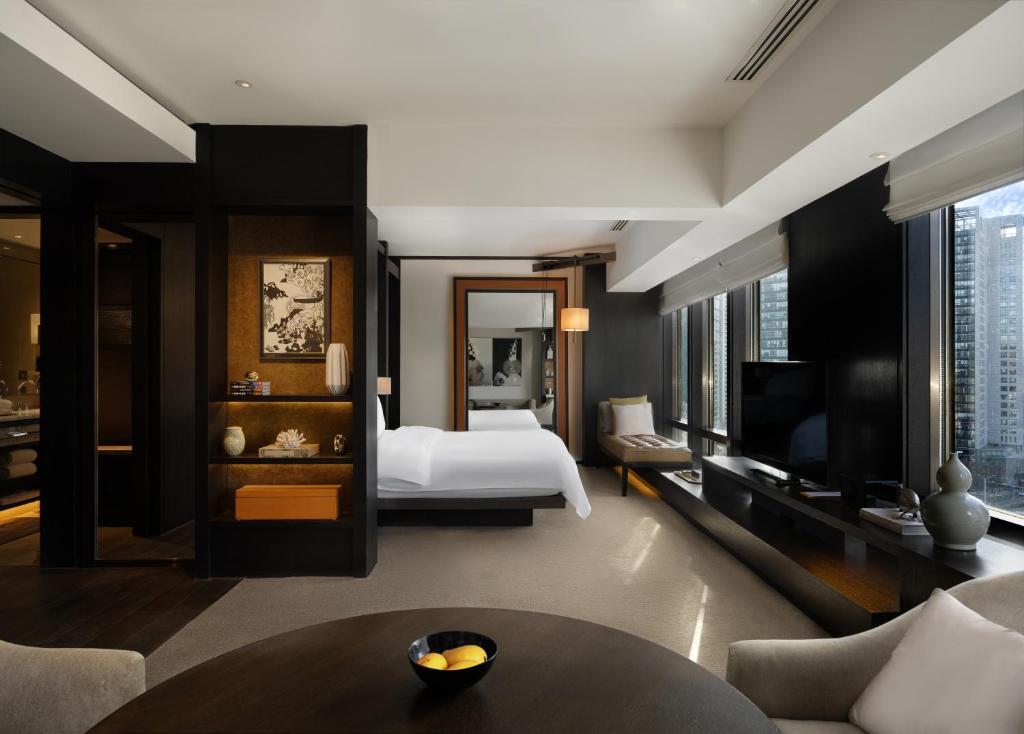 a hotel room with a bed and a television at Rosewood Beijing in Beijing