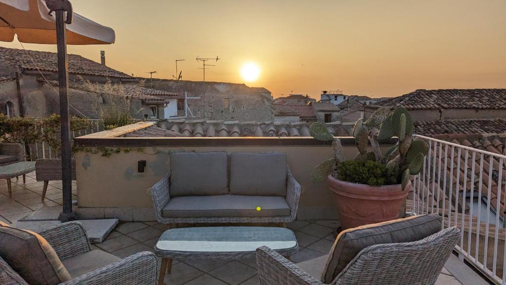 a patio with a couch and chairs on a balcony at Le Terrazze in Tropea