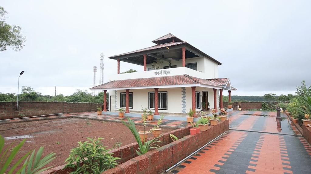 a small white house with a roof at Gokarna villa Tondavali in Achra