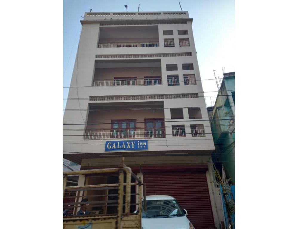 a building with a car parked in front of it at Galaxy Inn, Agartala in Agartala