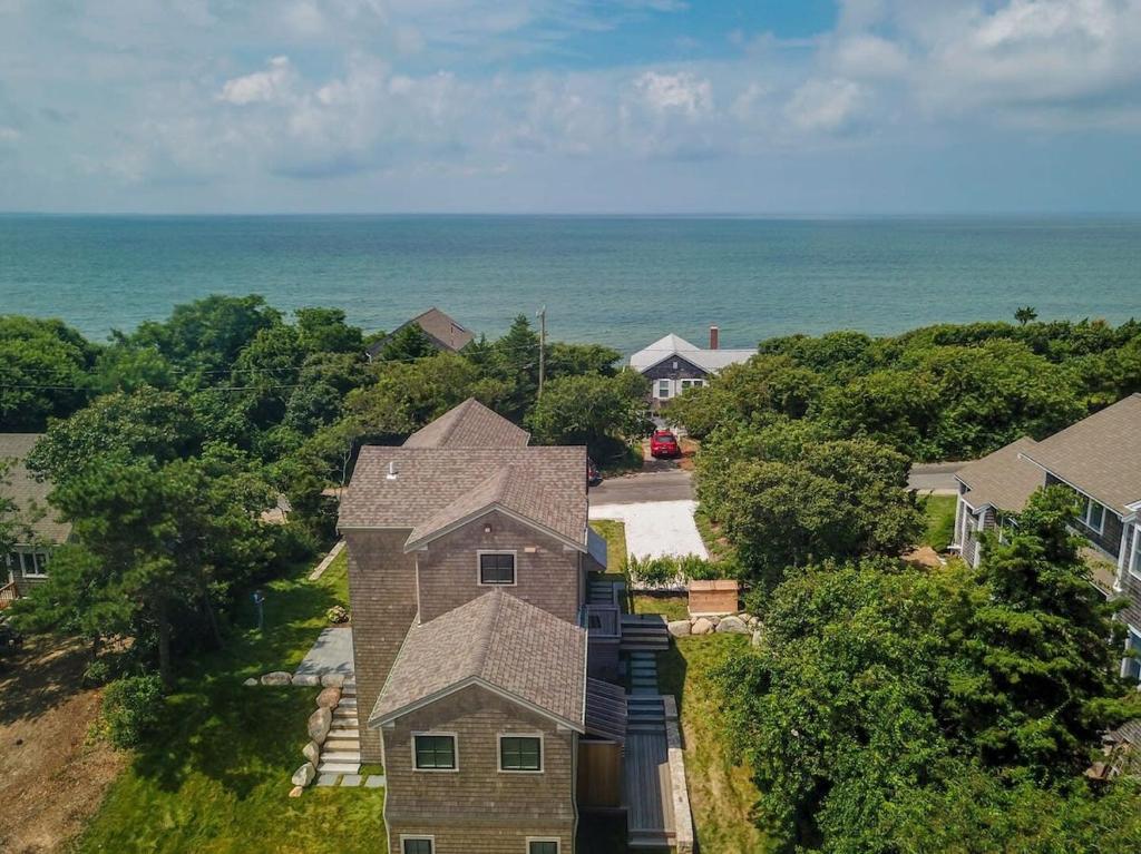 an aerial view of a house with the ocean in the background at Gorgeous Architectural Home w Water Views in Eastham