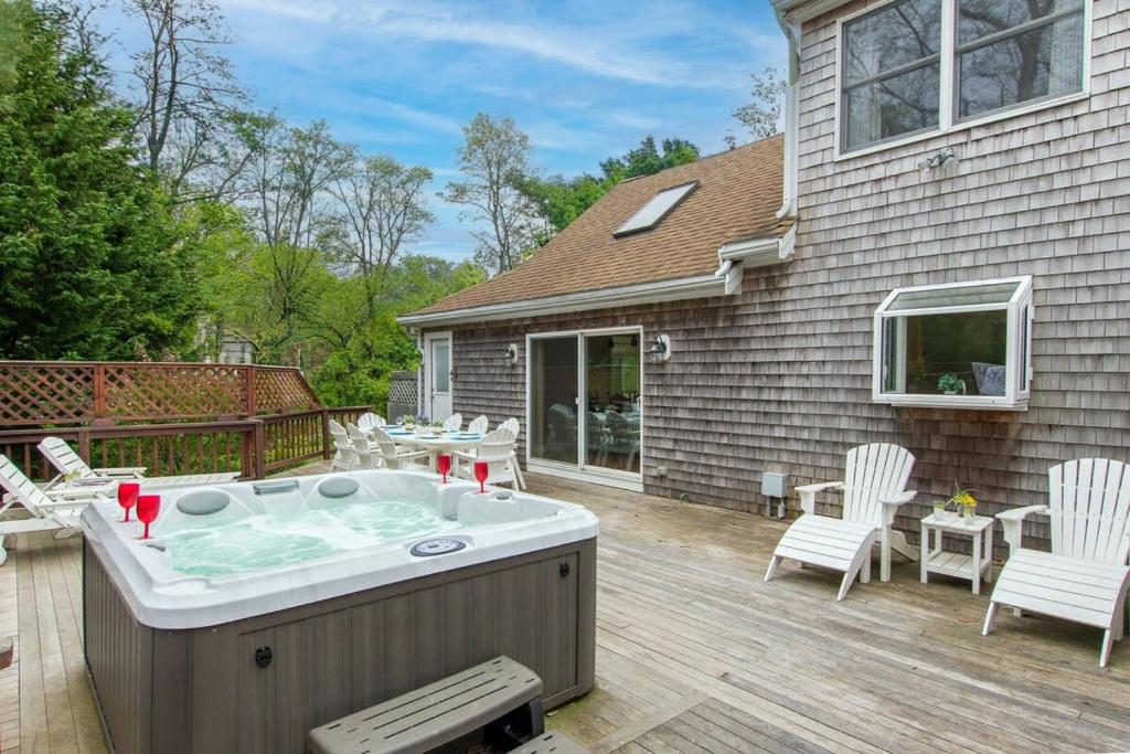 a hot tub on the deck of a house at 3000 Sq Ft Home with Hot Tub in Eastham