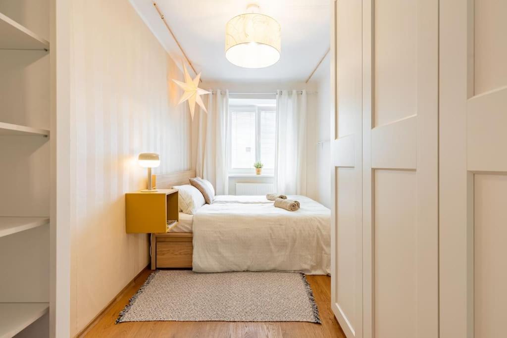 a small bedroom with a bed and a window at Tranquil Haven: Old Town Proximity in Bratislava