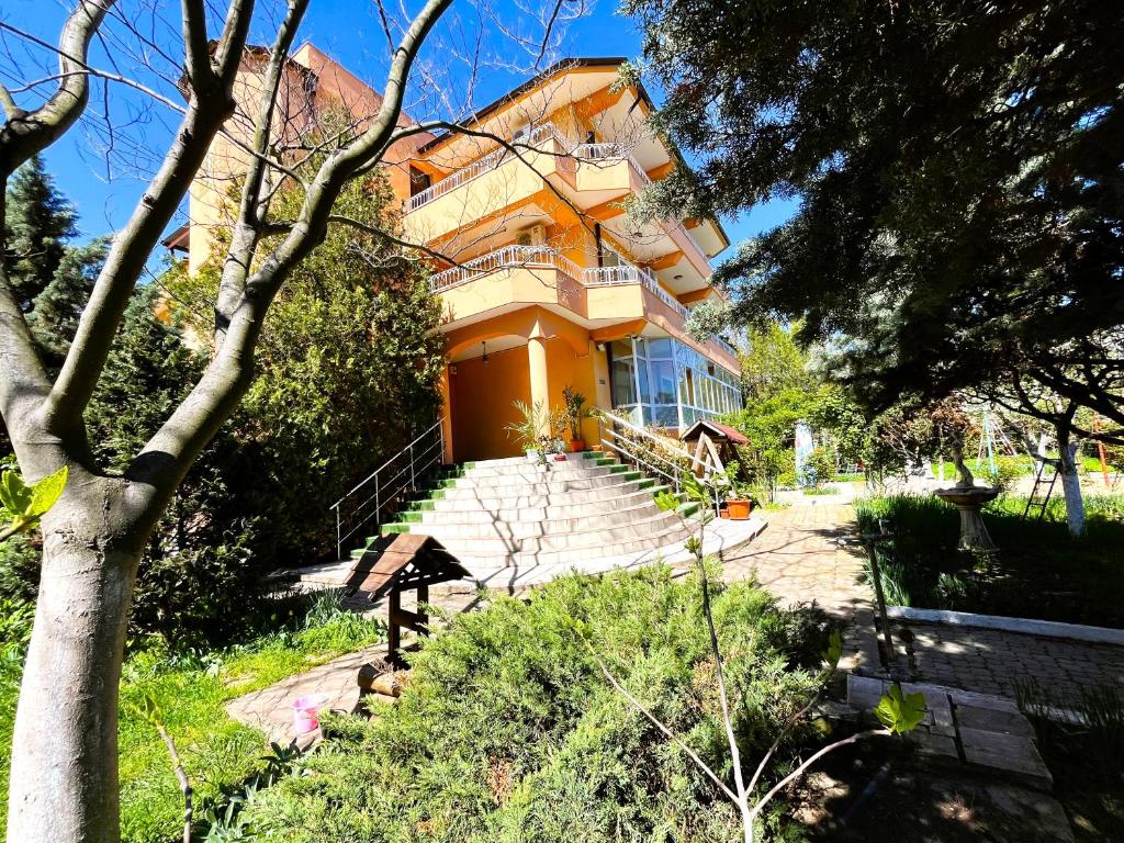 un edificio naranja con escaleras que conducen a él en Vila Egreta, en Eforie Nord