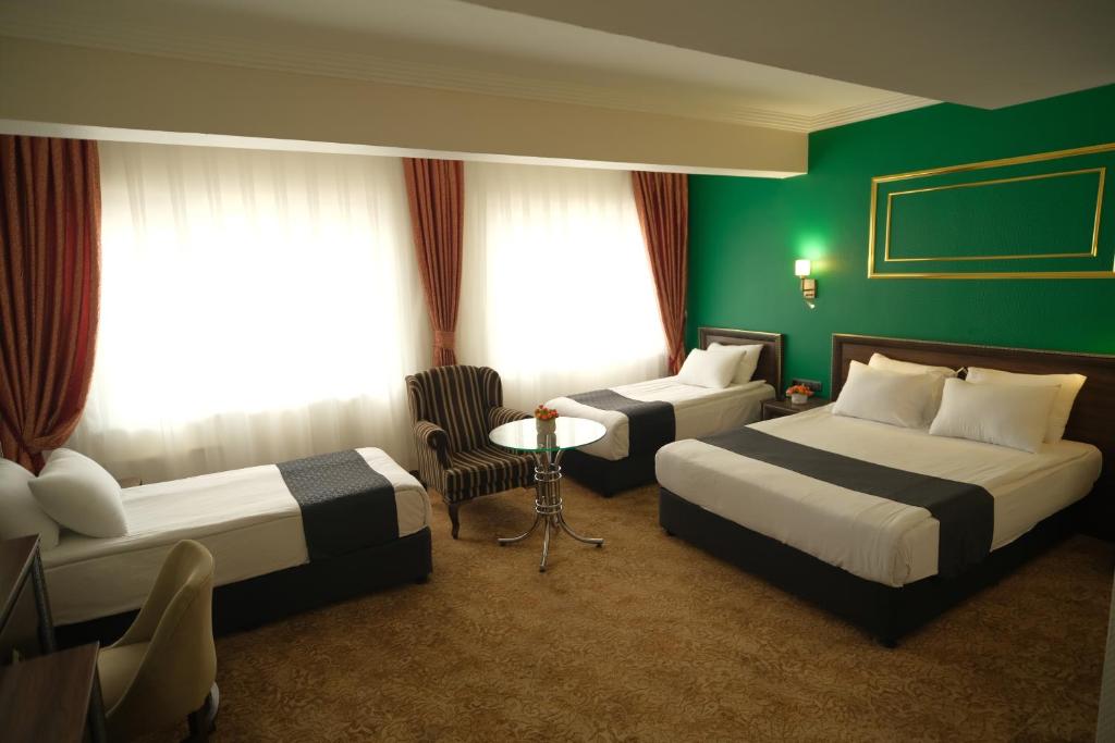 Postel nebo postele na pokoji v ubytování Malabadi Hotel