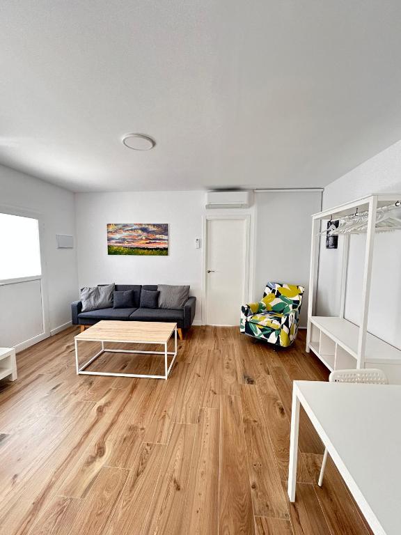 a living room with a couch and a table at Benicasim Village by Tucasanlaplaya in Benicàssim