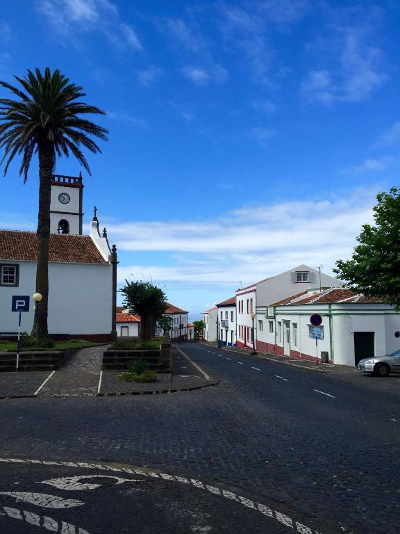 a street in a town with a clock tower at Casa da Avó - Vila do Porto in Vila do Porto
