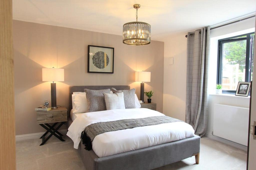 a bedroom with a bed and a chandelier at Cabot Mews Apartment 3 in Bristol
