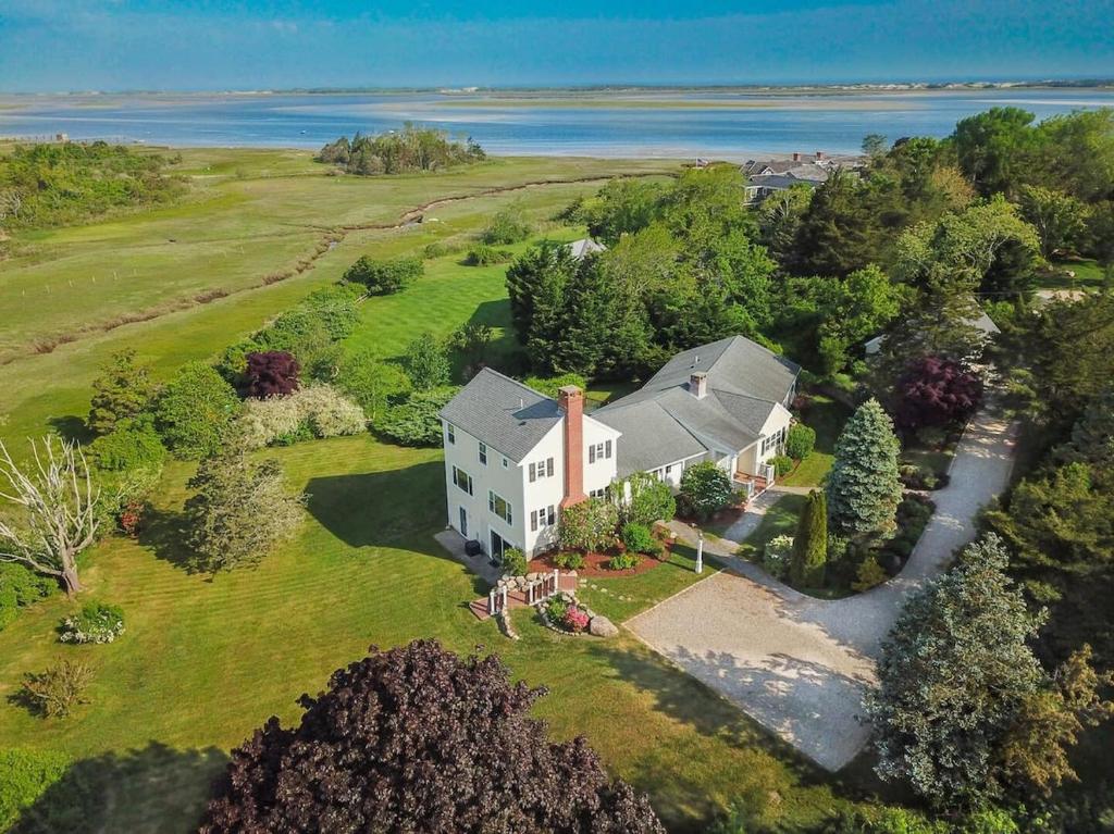 an aerial view of a white house on a field at Water Views & Private Tennis Court in Barnstable