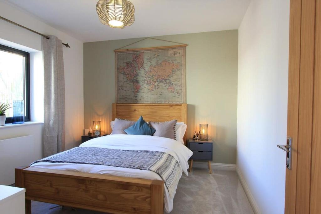 a bedroom with a bed with a map on the wall at Cabot Mews Apartment 4 in Bristol