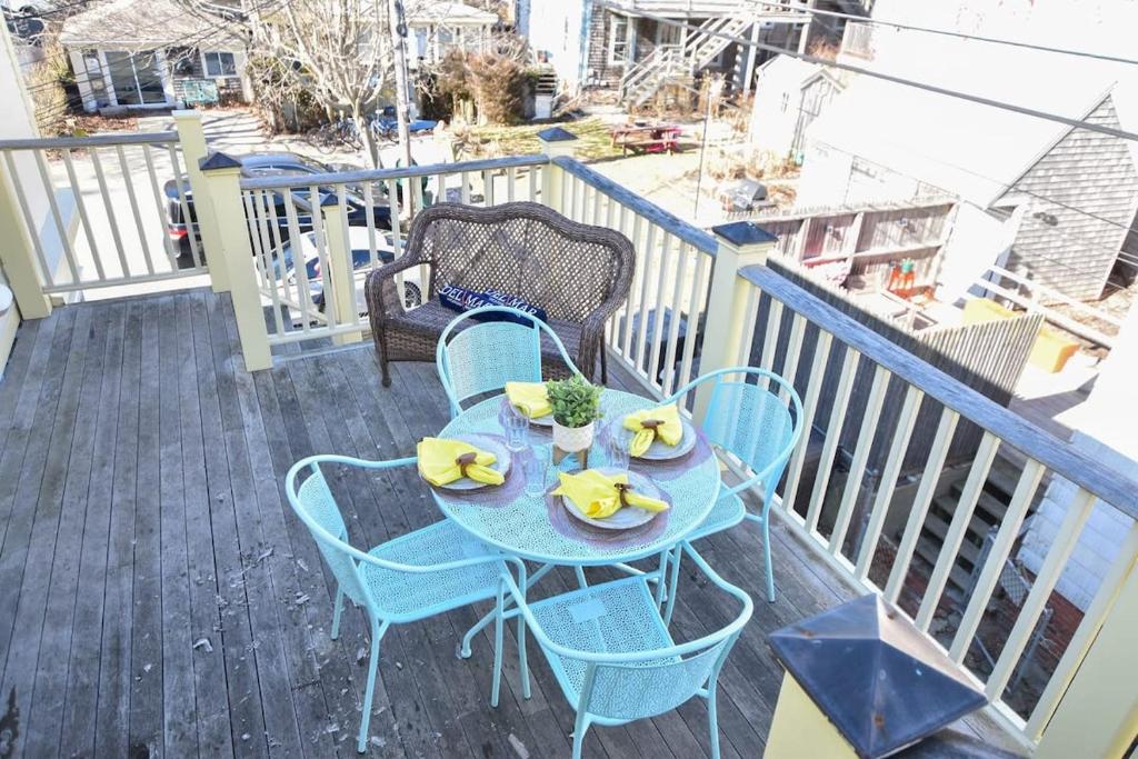 a table with bananas on it on a balcony at Rare Location on Commercial Street Exclusive Deck in Provincetown