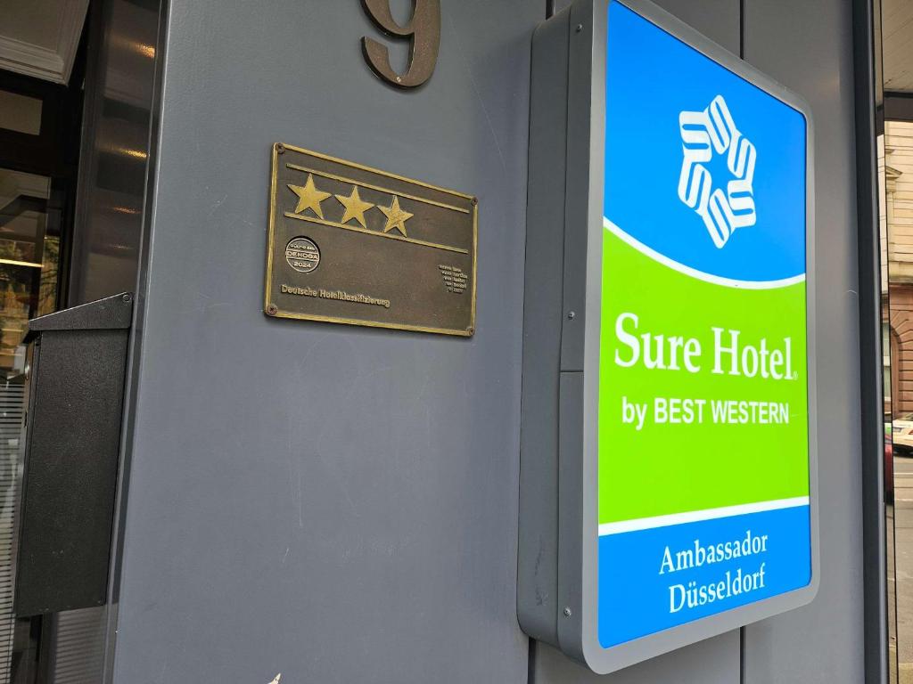 a sign on a building that says cure hotel by best museum at Sure Hotel by Best Western Ambassador Duesseldorf in Düsseldorf