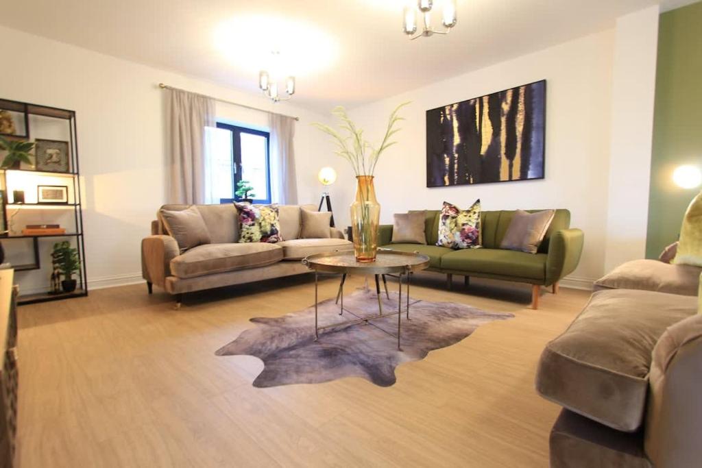 a living room with a couch and a table at Cabot Mews Apartment 8 in Bristol