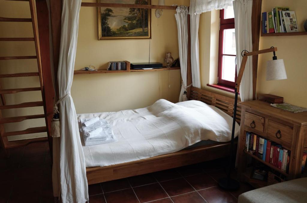 a small bed in a bedroom with a window at Apfelhof Biesenbrow in Biesenbrow