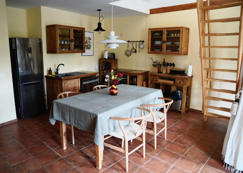 a kitchen with a table with chairs and a refrigerator at Apfelhof Biesenbrow in Biesenbrow