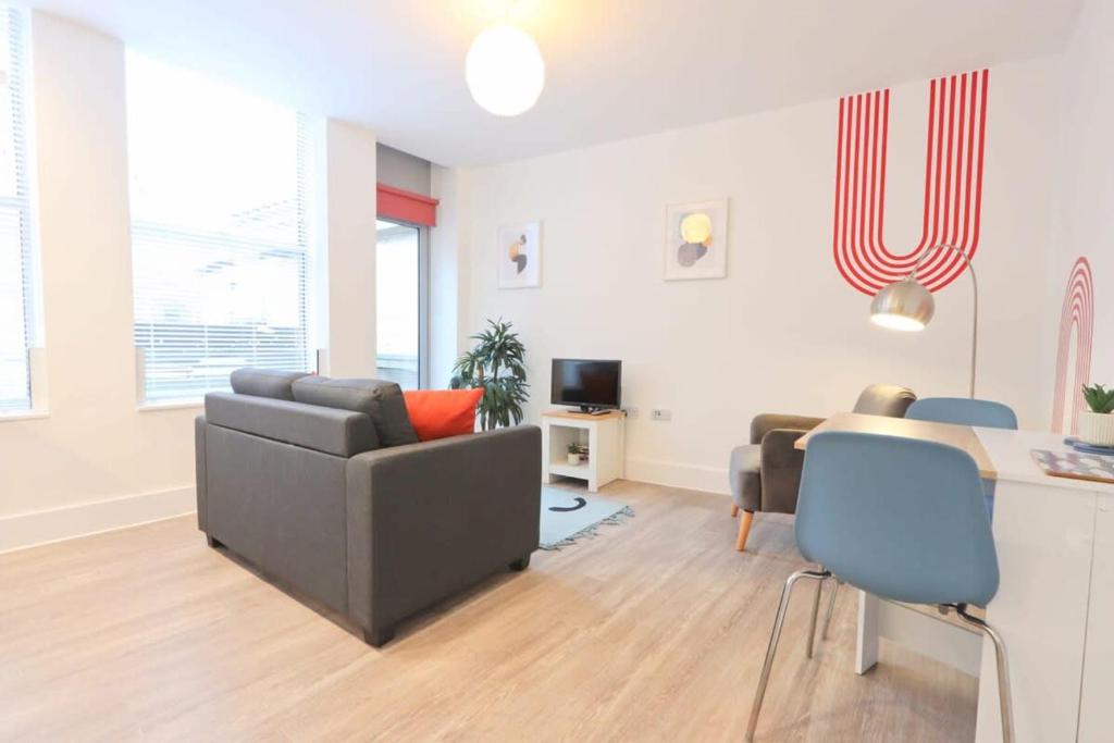 uma sala de estar com um sofá e uma mesa em Alliance House 203 em Bristol