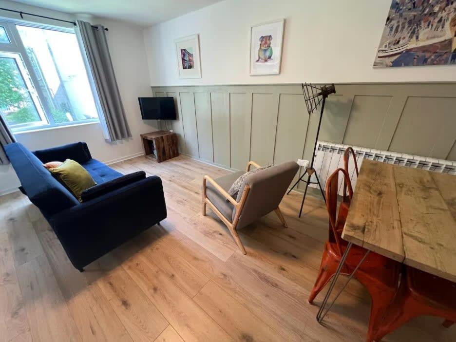 a living room with a couch and a table at Montague central one bedroom flat with parking in Bristol