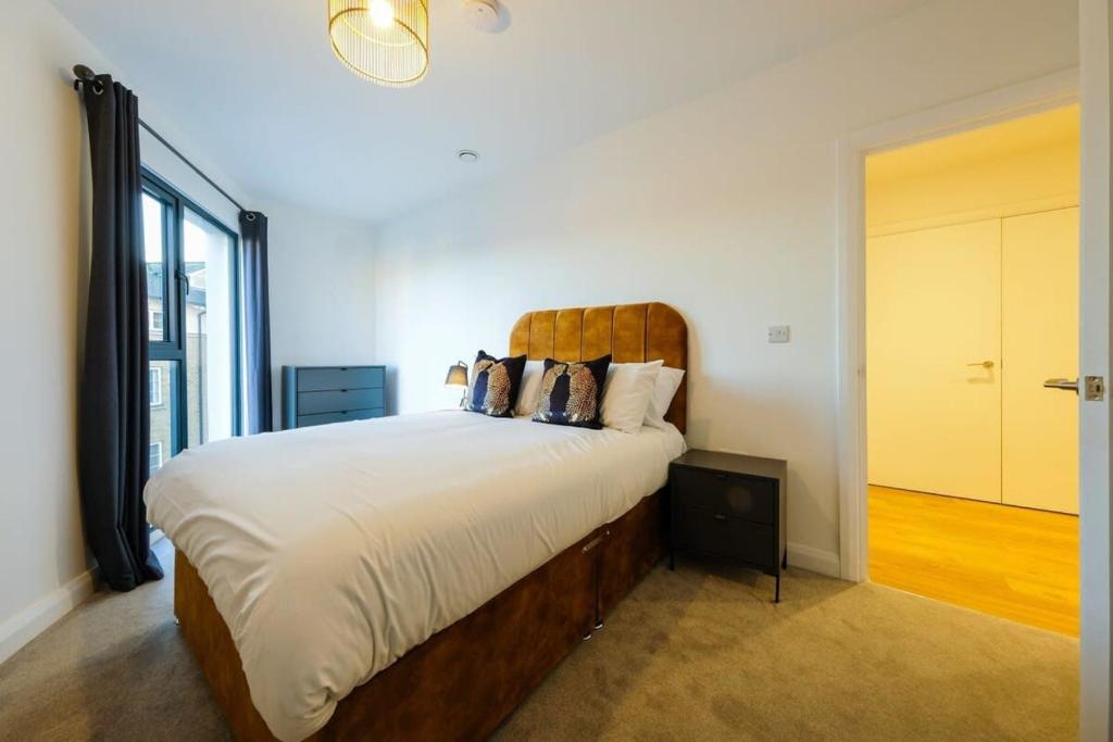 Schlafzimmer mit einem großen Bett mit einem Kopfteil aus Holz in der Unterkunft Hotwells apartments flat 6- Hopewell in Bristol