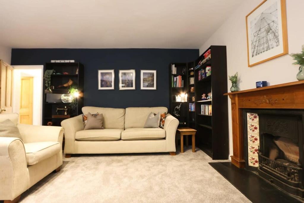 a living room with a couch and a fireplace at Cotham Vale 2 bedroom property in Bristol