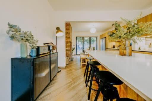a kitchen with a counter and some chairs and a counter top at The unicorn's house sleeps 10 people in Bristol