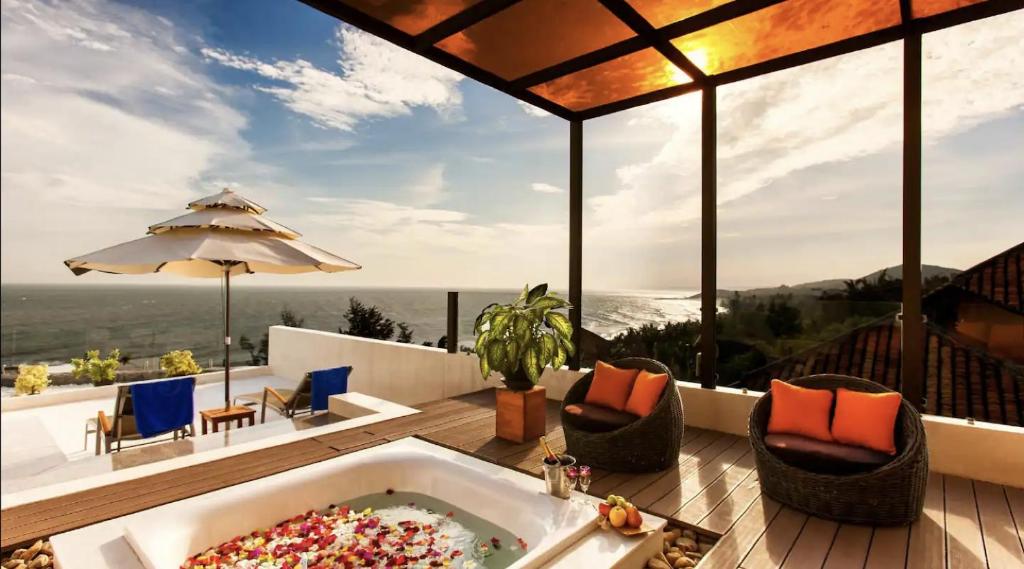 a large bath tub sitting on top of a deck at The Cliff Residence in Mui Ne