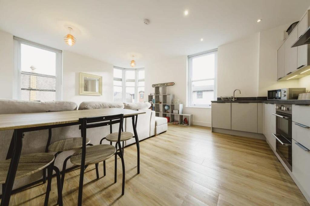 a kitchen and living room with a table and chairs at West Street 194- Hopewell in Bristol