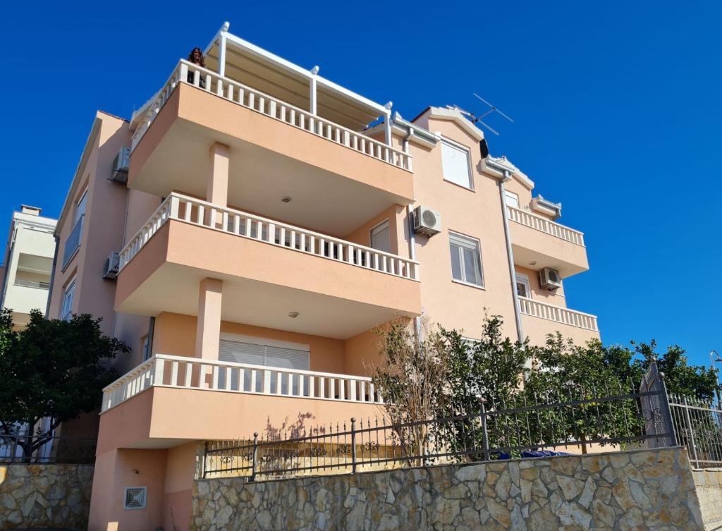 a building with balconies on top of a wall at Villa Maja in Trogir