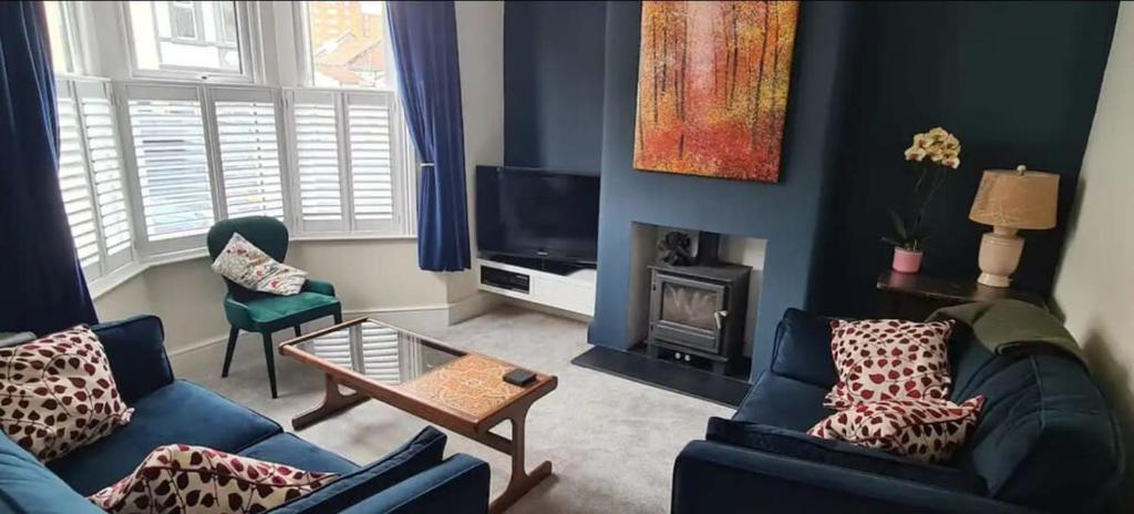 a living room with two couches and a tv at Stylish 3 bedroom Terraced house in Lime road in Bristol