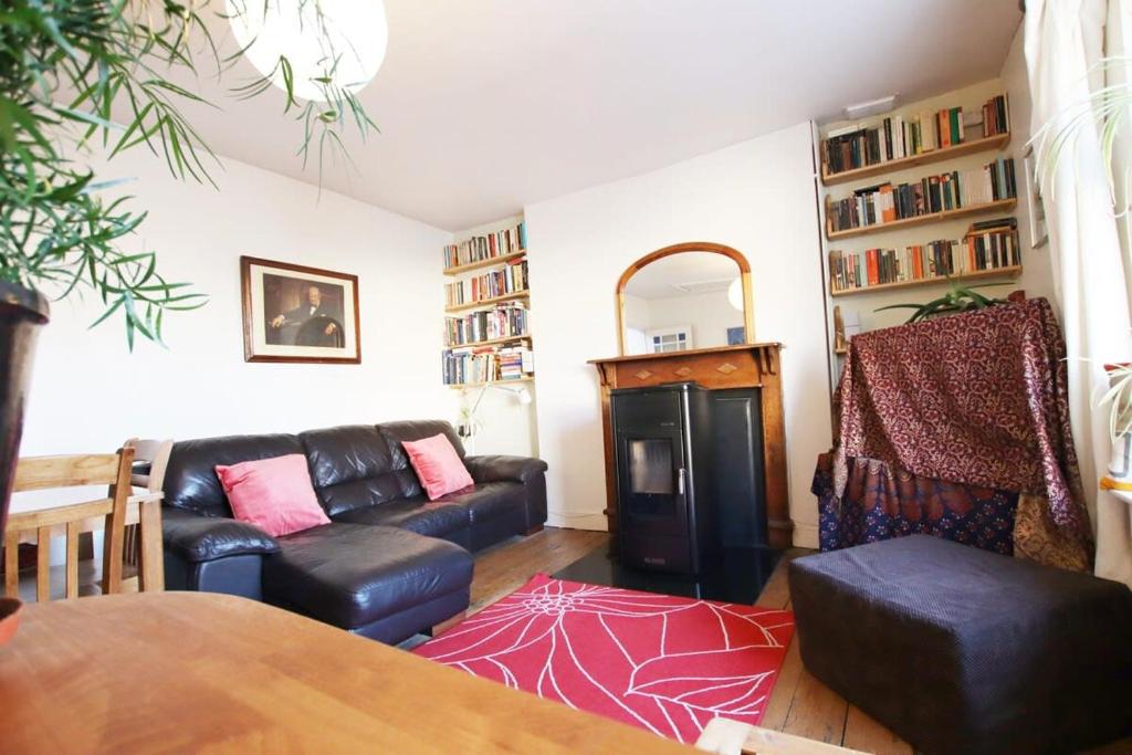a living room with a couch and a table at Bright one bed flat close to BRI & University in Bristol