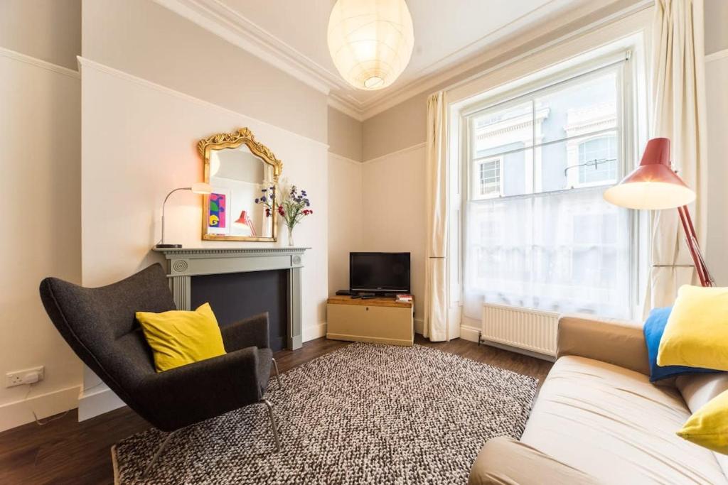 a living room with a couch and a mirror at Gorgeous flat in Heart of Clifton in Bristol