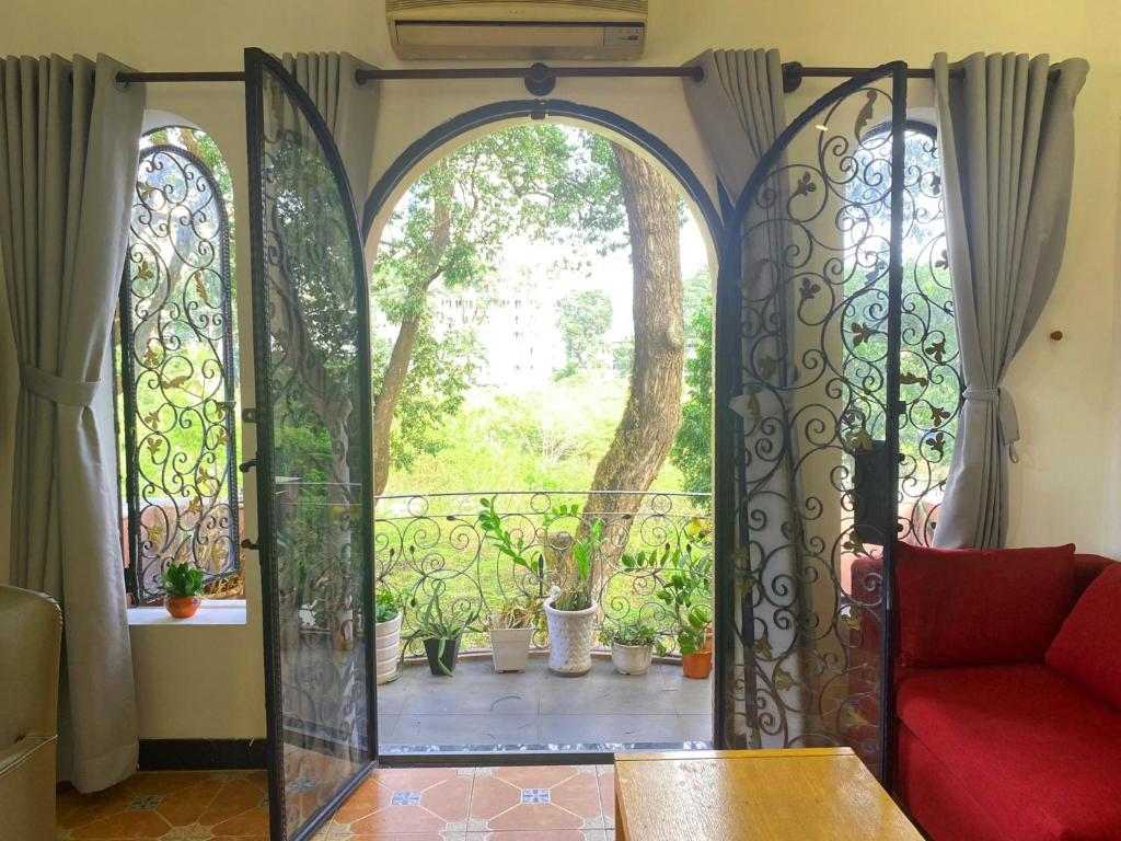 an open door to a balcony with a red couch at The Nest Homestay in Ho Chi Minh City