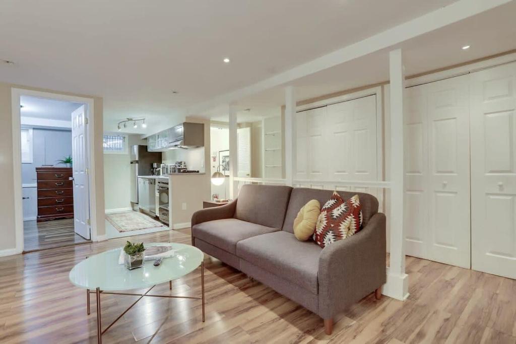 a living room with a couch and a table at Beautiful 2 Bedroom across from The House of Representatives in Washington