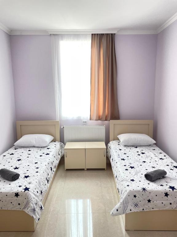 a bedroom with two beds and a window at LaoVardi Hostel in Gori