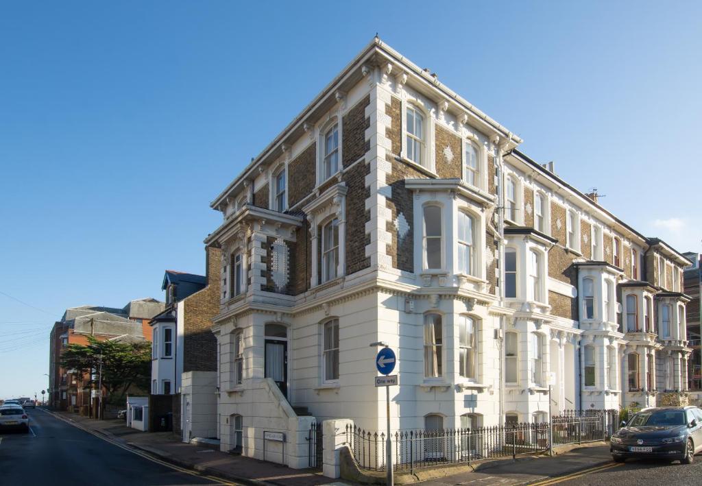 a large white building on the side of a street at Beautiful Victorian Coastal Holiday Home in Kent