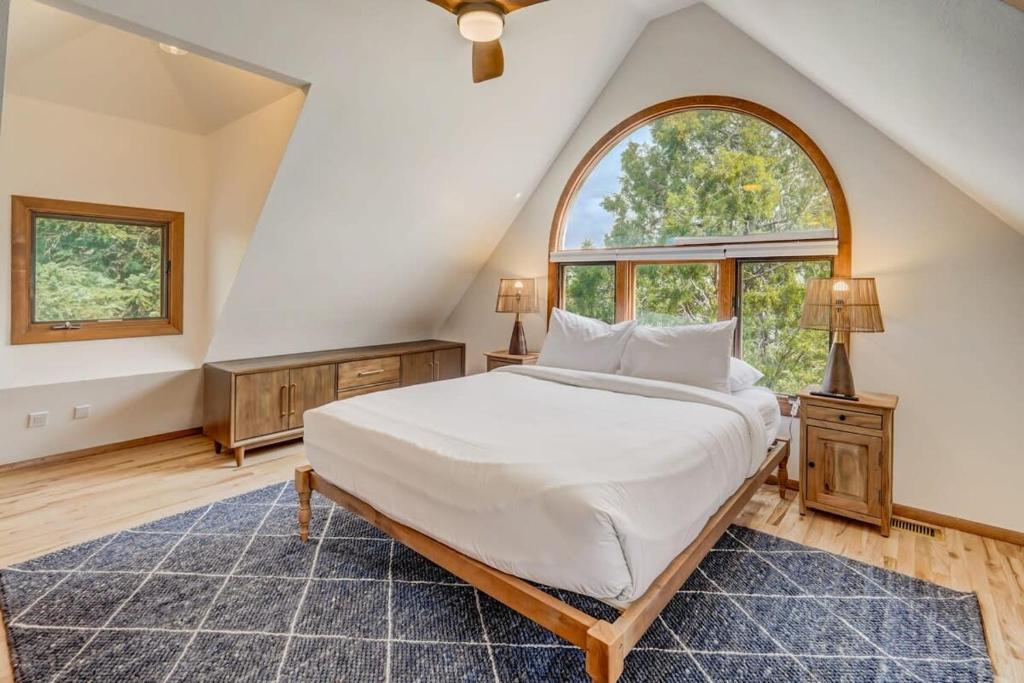 a bedroom with a large bed and an arched window at Garden of the Gods Base Camp Dog-Friendly in Colorado Springs