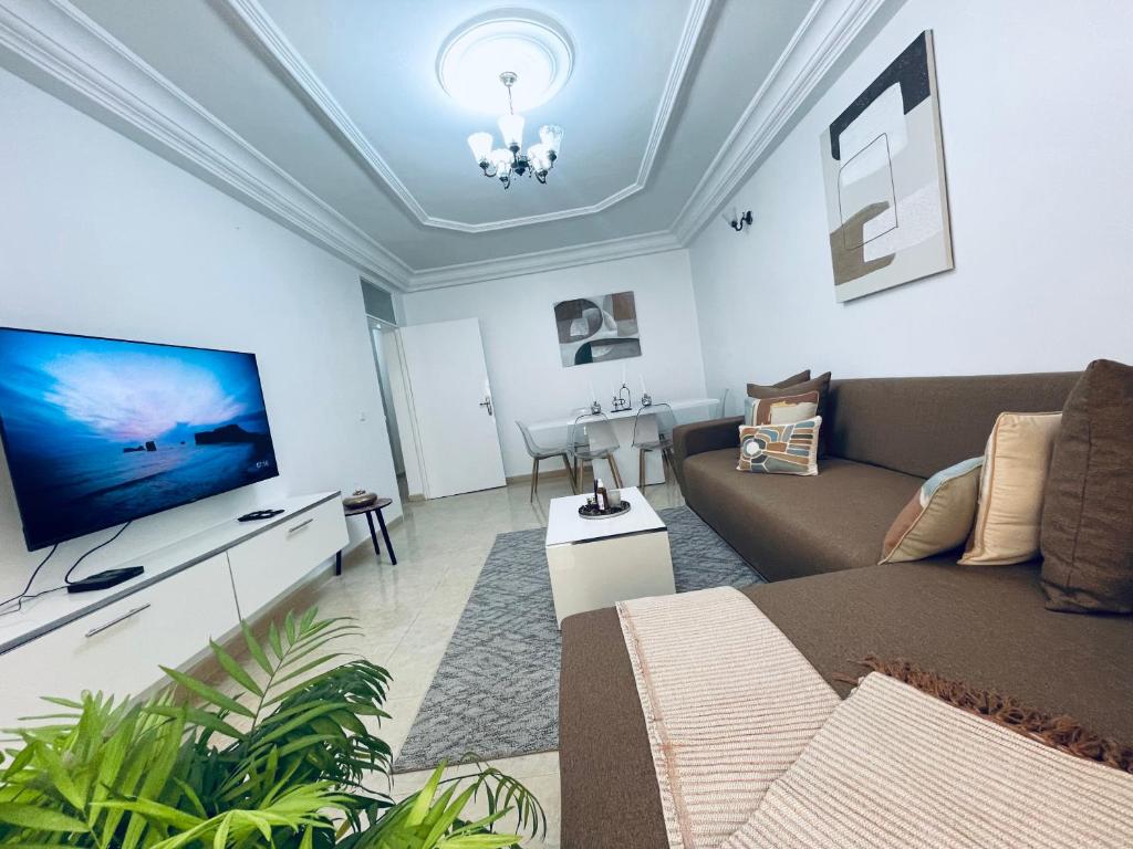 a living room with a couch and a flat screen tv at ESPACE VIRAGE 2 in Dakar