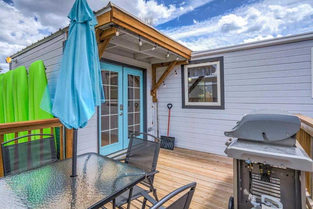 a patio with a table and an umbrella at 3BR Mountains-Nearby Lakes- Budget Getaway in Palmer Lake