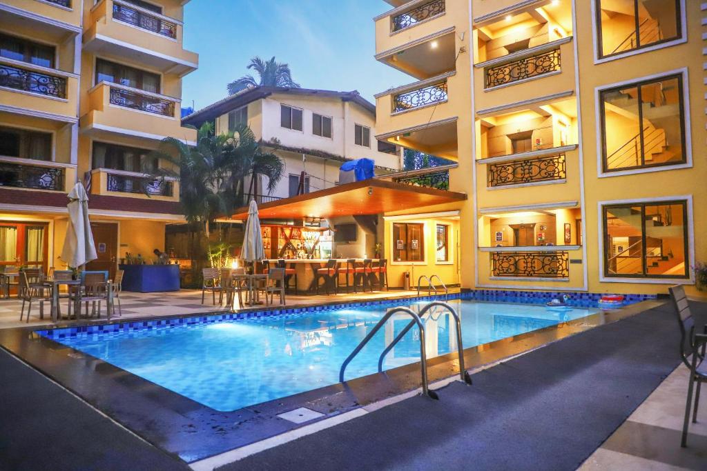 a swimming pool in front of a building at Resort De Coracao - Calangute , Goa in Calangute