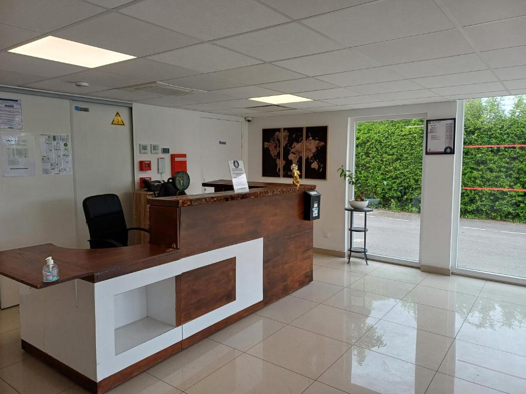 an office with a reception desk in a lobby at CRYSTAL HOTEL in Claye-Souilly