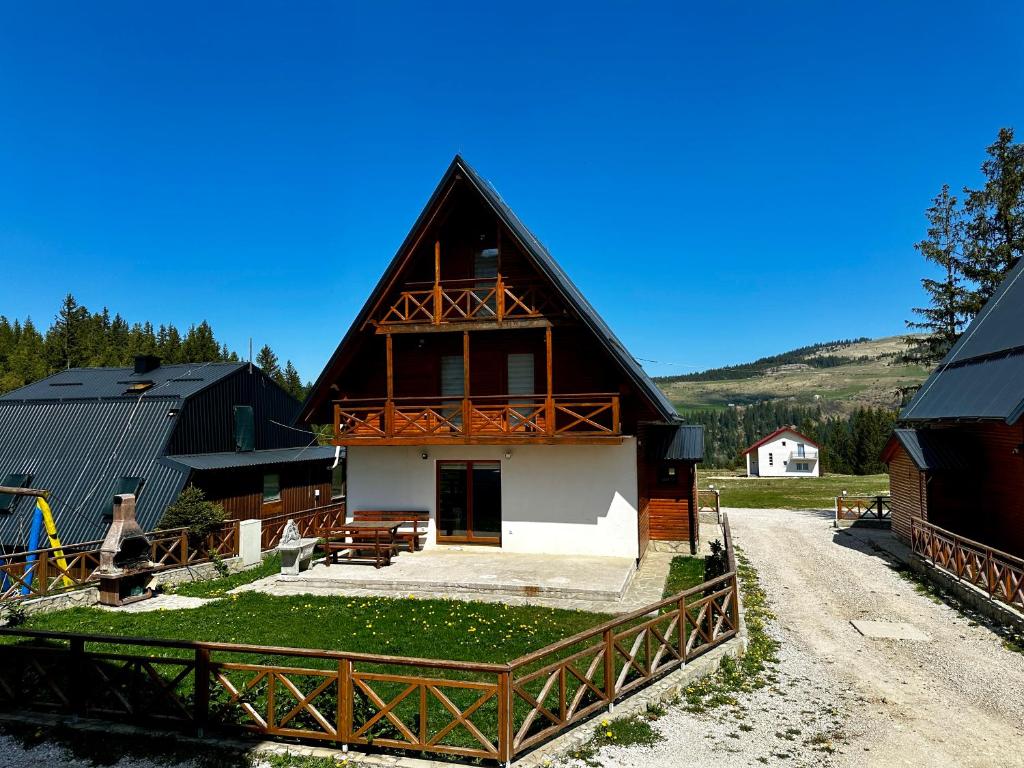 a large house with a porch on a farm at Holiday Home Krajina II in Vlasic