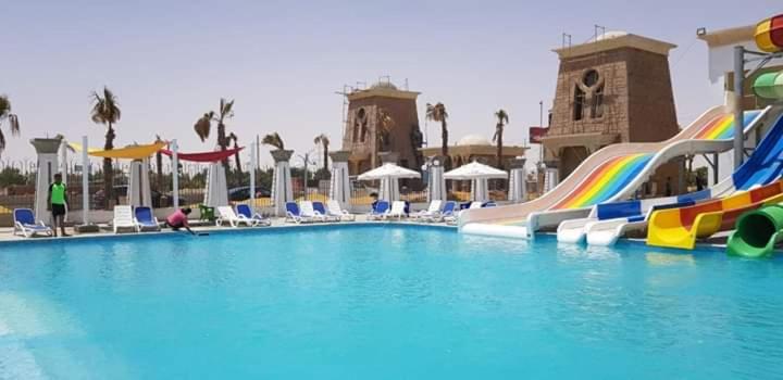 a swimming pool with a water slide in a resort at LASIRENA MANI EGYPT-Family Only in Ain Sokhna