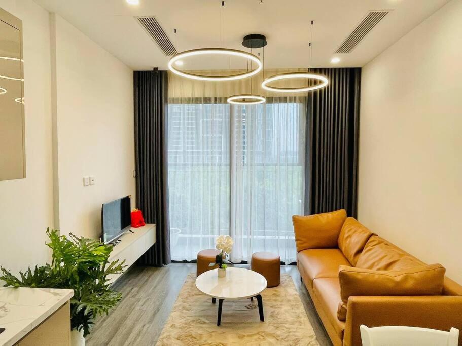 uma sala de estar com um sofá e uma mesa em 1 phòng ngủ Ruby cao cấp R105 em Gia Lâm Pho