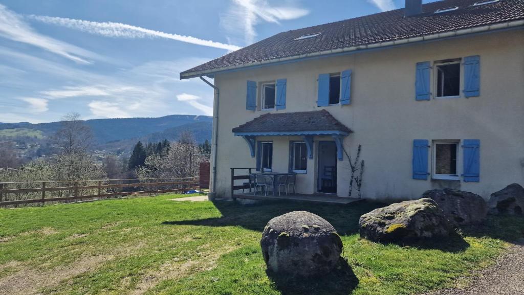 a white house with rocks in front of it at Le Petit Hangy in Fresse-sur-Moselle