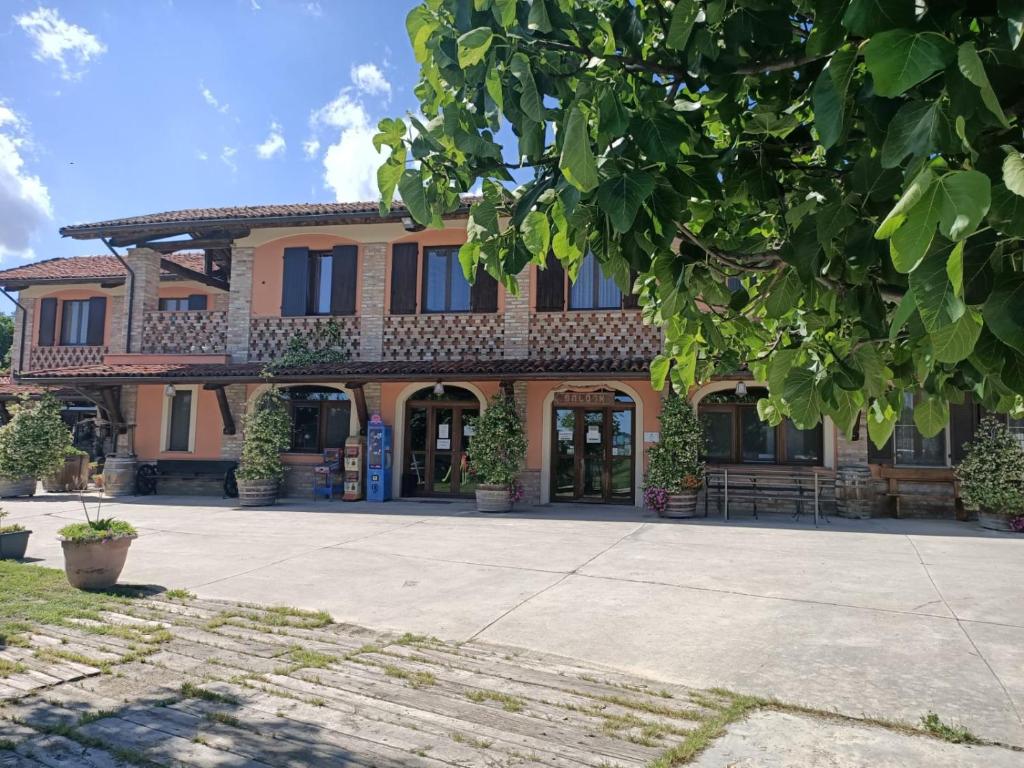 a large building with a courtyard in front of it at Agriturismo Vecchio Torchio in Canelli